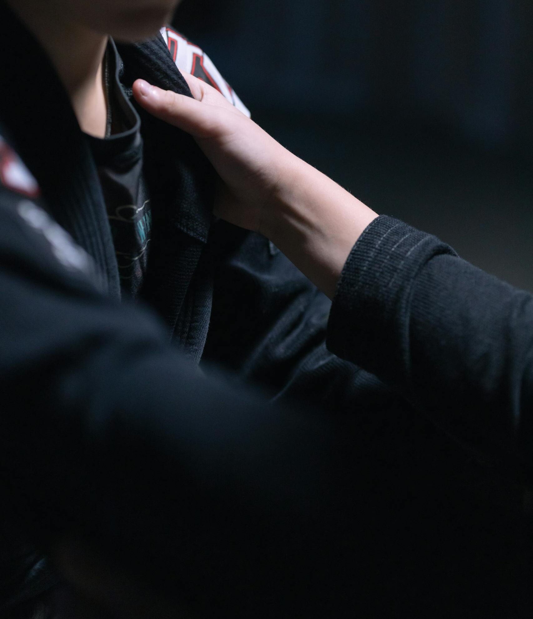 A close-up image of young jiu jitsu practitioners in a focused training moment.